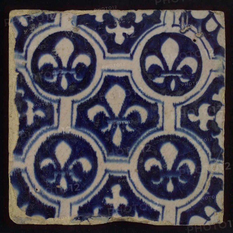 Two-tone tile, blue on white background, finished painting, four circles with white French lily around central ornament with