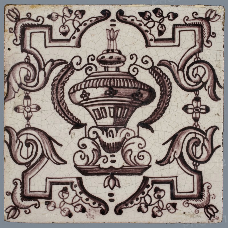 Tile, purple on white, vase with round floral ornaments, framed by régence decoration, wall tile tile sculpture ceramic