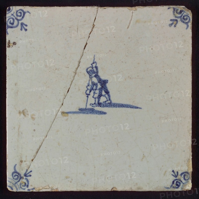 Scene tile, figure with pole vault, corner motif ox's head, wall tile tile sculpture ceramic earthenware glaze, baked 2x glazed