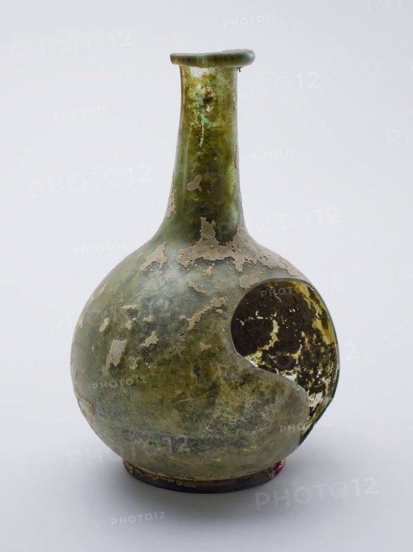 Bulky (medicine?) Bottle, bottle holder bottomfound glass, free blown and shaped Bolbuikig (medicine?) Bottle in clear light