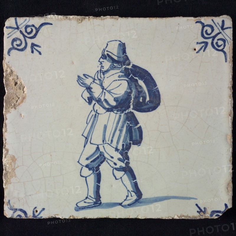Occupation tile, blue with man with hat and bag over the shoulder, corner pattern ox-head, wall tile tile sculpture ceramic