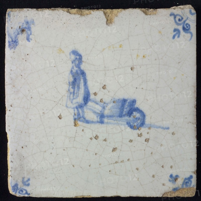 Occupation tile, blue with standing man with wheelbarrow, corner motif of ox's head, wall tile tile sculpture ceramic