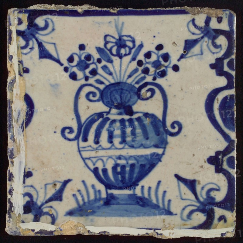 Flowerpot, flowerpot between balusters in blue on white, corner pattern french lily, white paint on the tile, wall tile