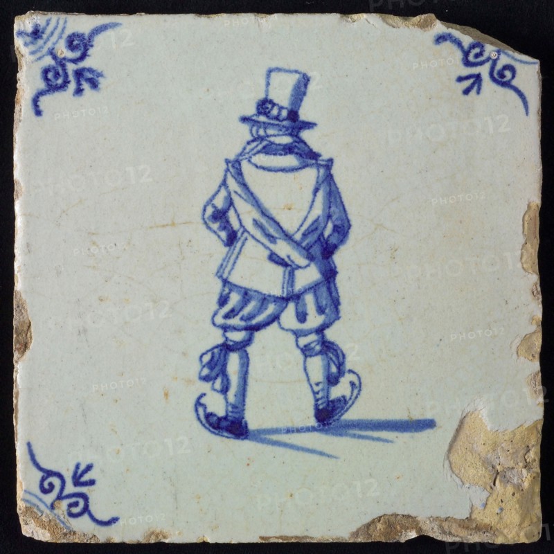 Figure tile, blue with skating man, seen from behind, nobleman with top hat, corner pattern ox head, wall tile tile sculpture