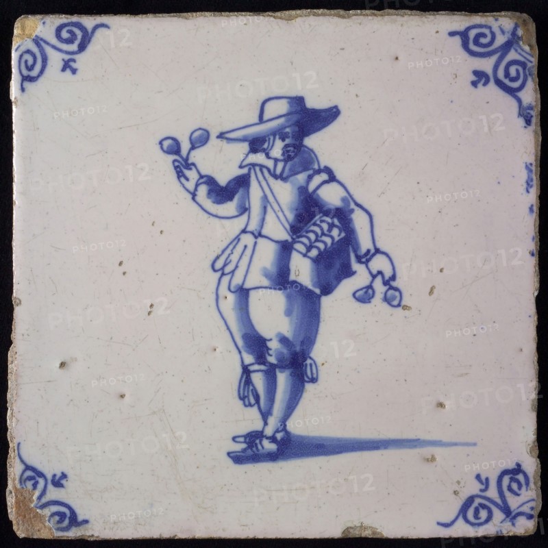 Occupation tile, blue with spectacle vendor, corner motif oxen head, wall tile tile sculpture ceramic earthenware glaze wood
