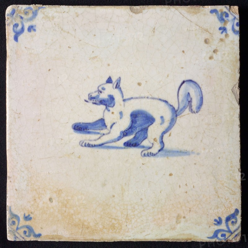 Animal tile, standing dog to the left, in blue on white, corner motif ox's head, wall tile tile sculpture ceramic earthenware