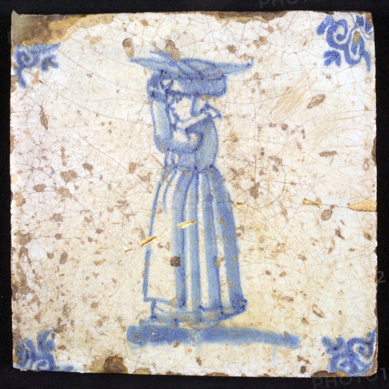 Figure tile, blue with woman with basket with fish on the head, corner pattern ox's head, wall tile tile sculpture ceramic