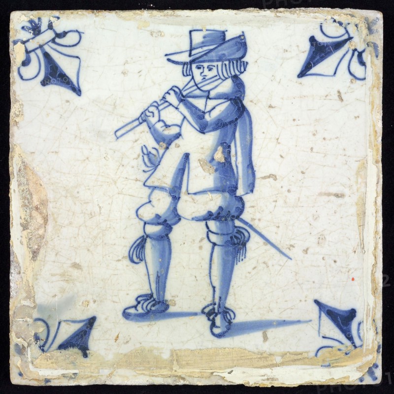 Figure tile, blue with flute player, corner motif lily, wall tile tile sculpture ceramic earthenware glaze, baked 2x glazed