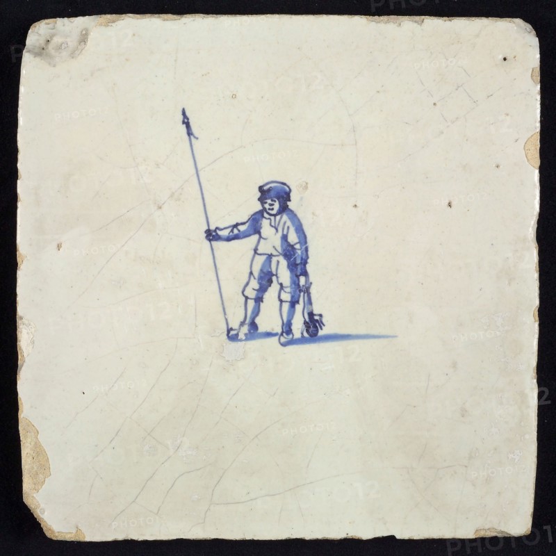 Figure tile, blue with shepherd with staff and dead rabbit in hand, no corner motif, wall tile tile sculpture ceramic