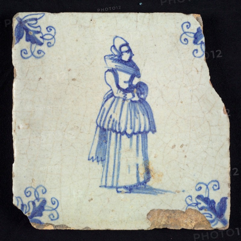 Figure tile, blue with standing lady with millstone collar and included overcoat, corner motif, vane leaf, wall tile
