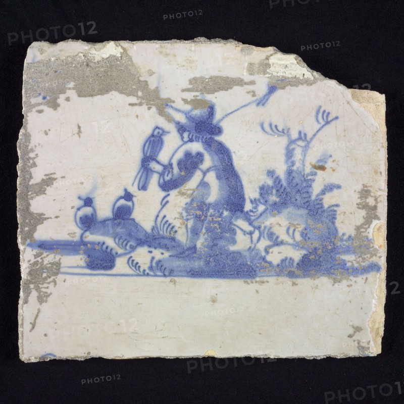 Figure tile, blue with landscape with walking shepherd with bird on the hand, corner pattern spider, wall tile tile sculpture