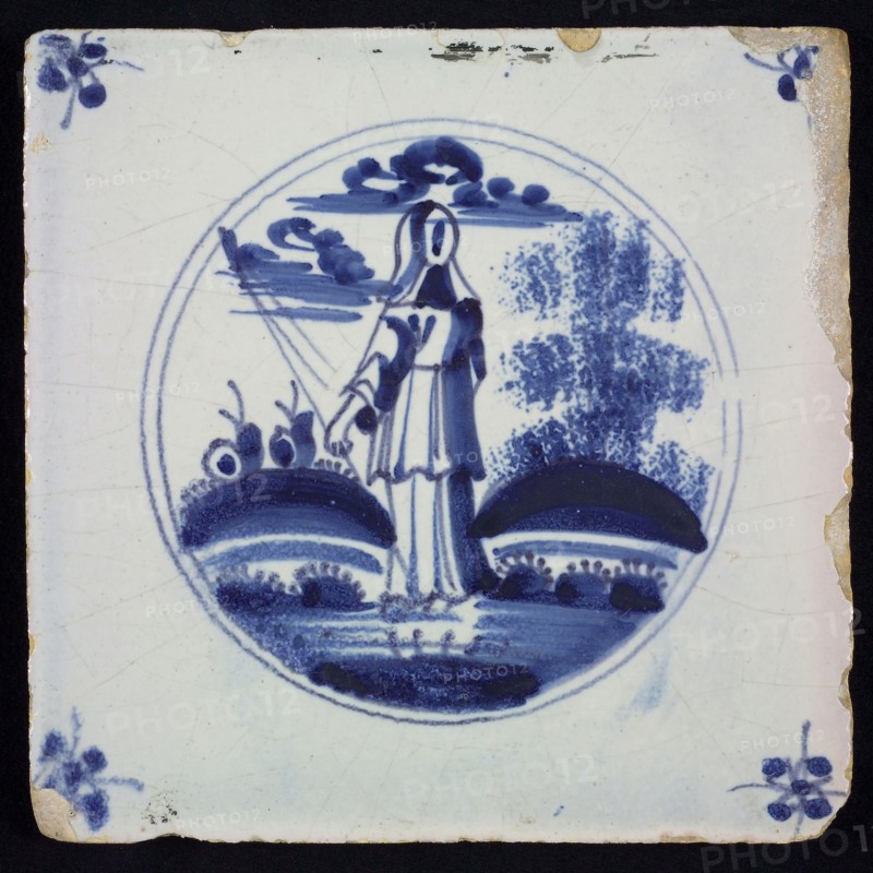 Scene tile, blue with scene decoration with shepherdess seen on the back, in circle frame with corner motif spider, wall tile