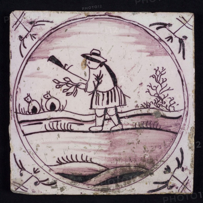 Scene tile, purple with scene decoration with shepherd with branch and staff, in circle frame with corner motifs ox head, wall