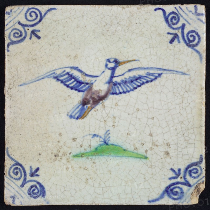 Animal tile, flying bird to the right in purple, green and blue on white, corner pattern ox head, wall tile tile sculpture