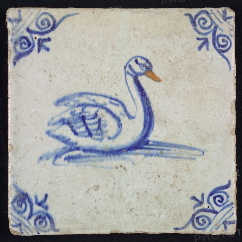 Animal tile, bird in water to the right in orange and blue on white, corner motif ox's head, wall tile tile sculpture ceramic