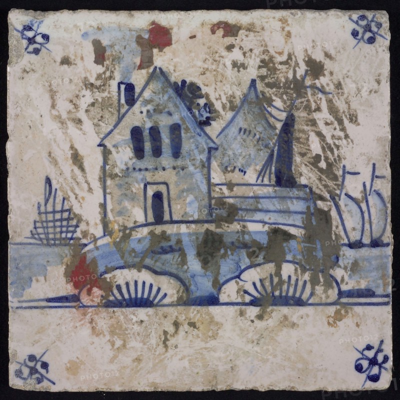 Scene tile, blue with landscape with house and sailing ship, sailing ships in the background, corner motif spider, wall tile