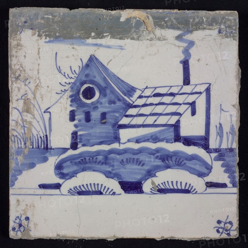 Scene tile, blue with landscape with house and barn, corner motif spider, wall tile tile sculpture ceramic earthenware glaze