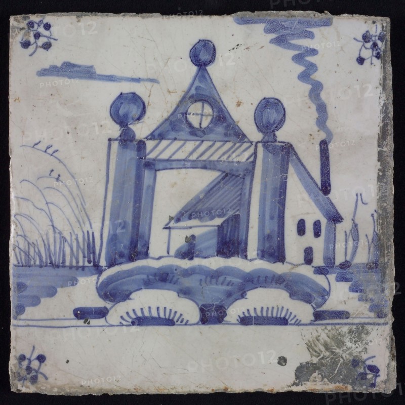 Scene tile, blue with landscape with gate with columns and tympanum, behind it house, corner motif spider, wall tile
