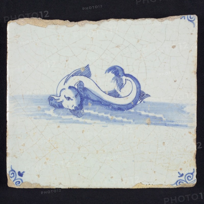 Animal tile, unknown fish in water to the left, in blue on white, corner motif of ox's head, wall tile tile sculpture ceramic