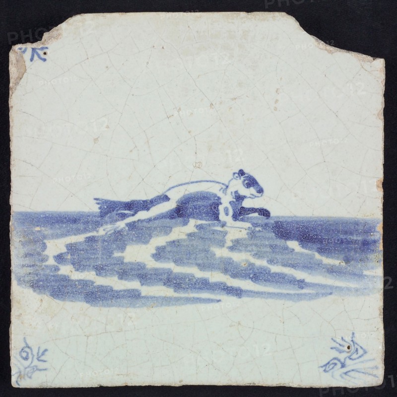 Animal tile, sea-washed in continuous water to the right, in blue on white, corner motif of ox-head, wall tile tile sculpture