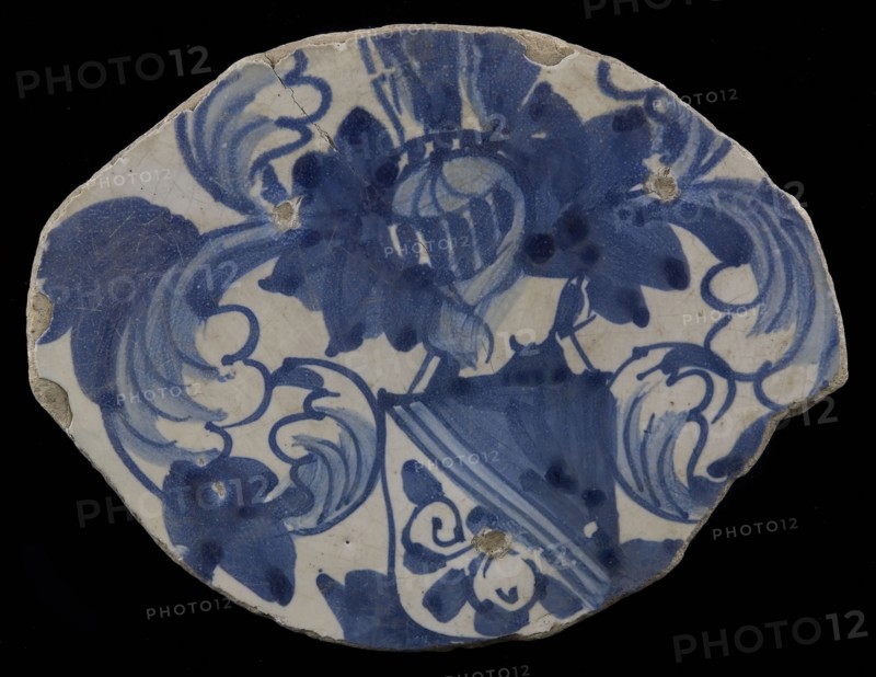 Fragment majolica dish, blue on white, heraldic image, helmeted escutcheon with diagonal division, above dark, under light with