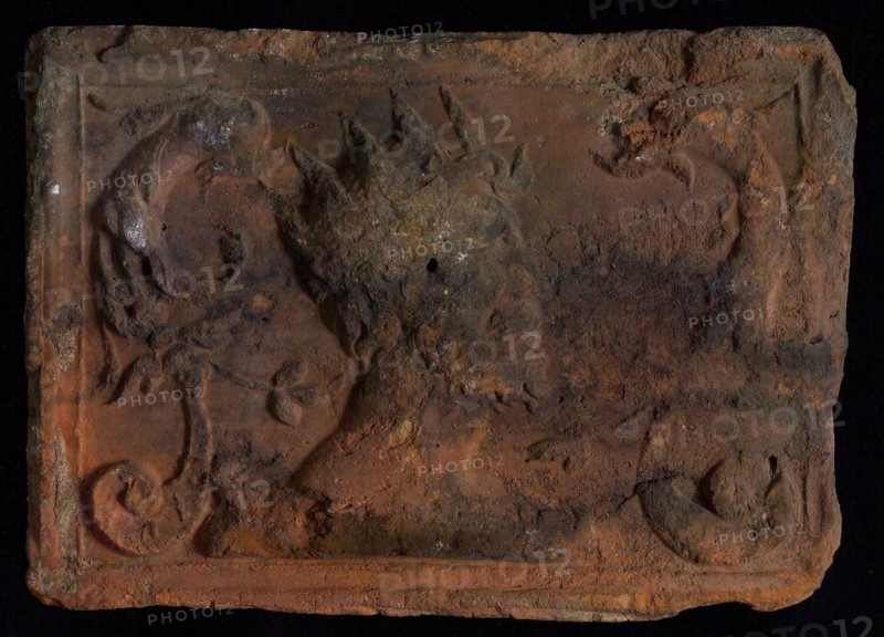 Hearthstone, from Antwerp Belgium, with narrow frame, with crowned man and dolphinvoluten, hearth fireplace part ceramic brick