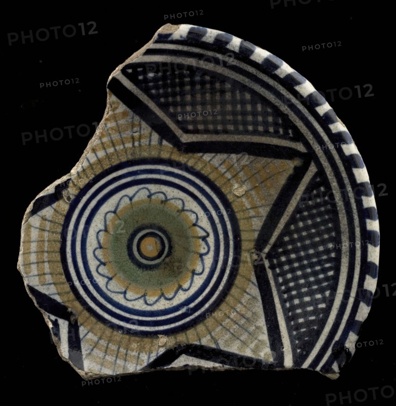 Fragment of the majolica dish, polychrome, in the middle rosette, outside of that star motif, plate crockery holder soil find