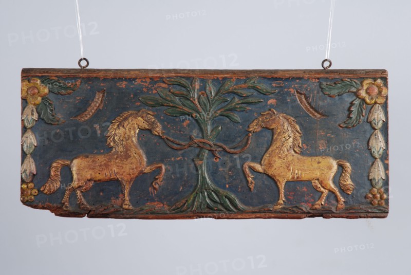 Wooden painted back plate of farm wagon, with image two gilded horses tied to tree, back crate wood carving sculpture footage