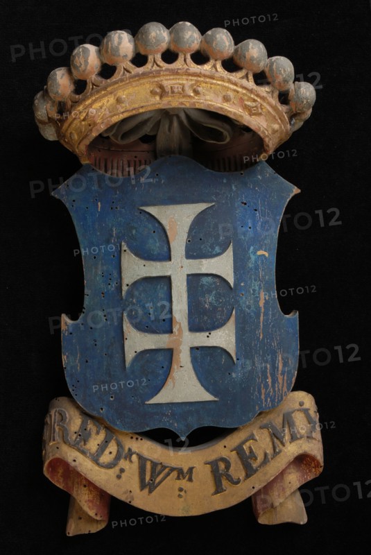 Carved wooden crowned coat of arms including the name Fred.K Wm. Remy, coat of arms information form wood carving sculpture