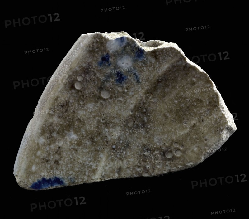 Fragments of two majolica dishes fused together, blue on white, loose motifs on the rim, plate dish crockery holder earth