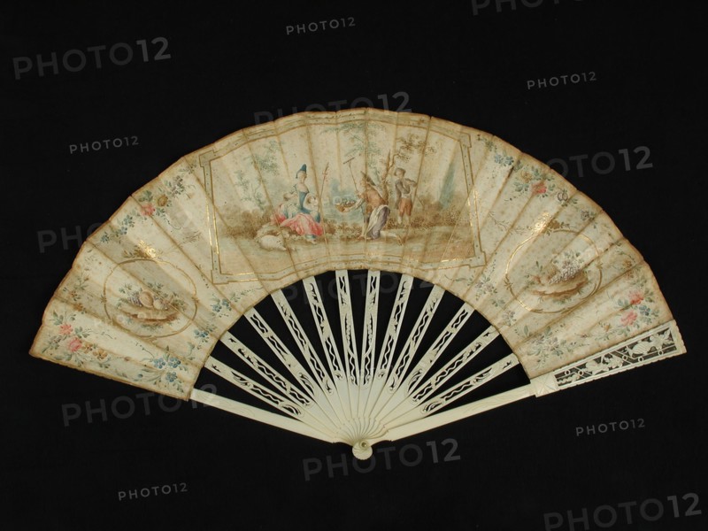 Folding fan with carved ivory frame and multicolored painted parchment leaf with rococo motifs and pastoral scene, folding fan