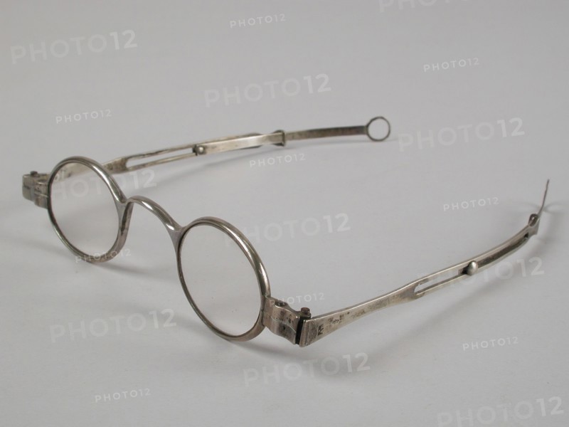 Glasses with oval lenses on strength, silver frame and adjustable straight feathers, spectacle eye lens equipment glass metal