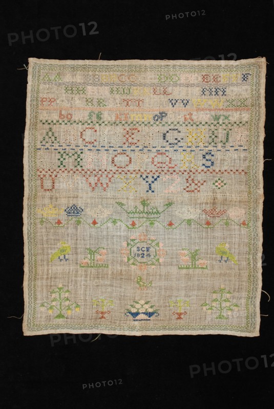 Sampler or letterlap worked in cross stitch in colored silk on loosely woven linen, marked SCF 1824, lettercloth sampler
