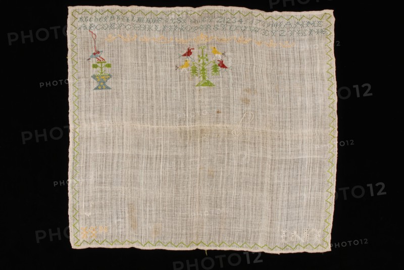 Unfinished sampler or lettercloth worked in cross stitch in colored silk on loose woven unbleached linen, marked LNI, sampler