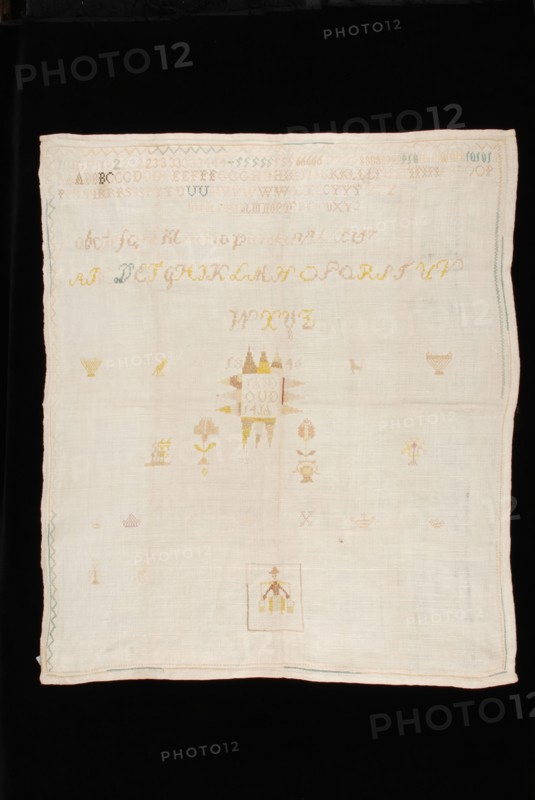 Unfinished sampler or lettercloth worked in cross stitch in colored silk and linen on unbleached linen, marked J, textile