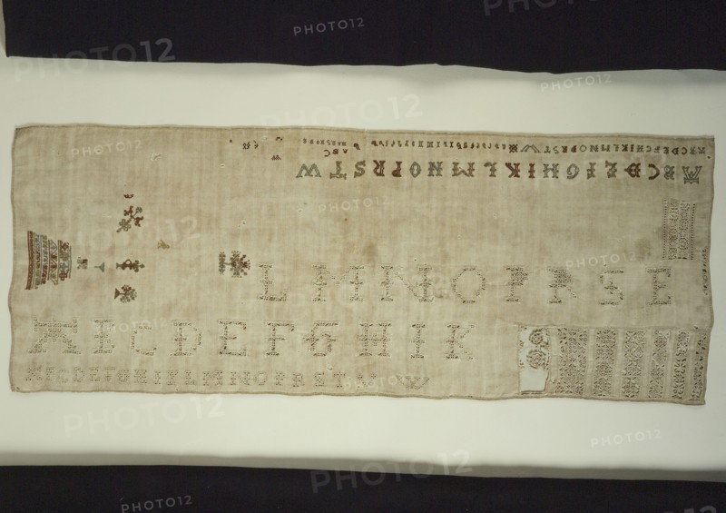 Sampler or lettercloth worked in colored silk and natural linen on cream colored linen in cross stitch and reticella