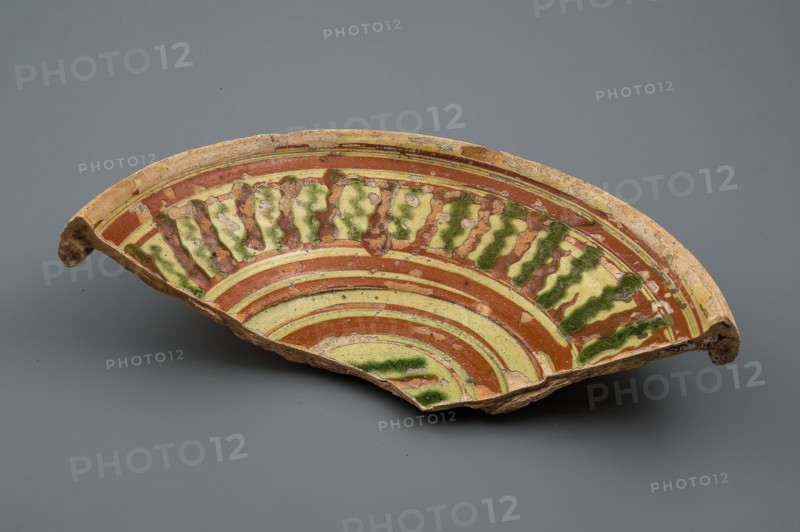 Fragment earthenware dish with green and brown silt decoration on yellow ground, plate dish crockery holder soil find ceramic