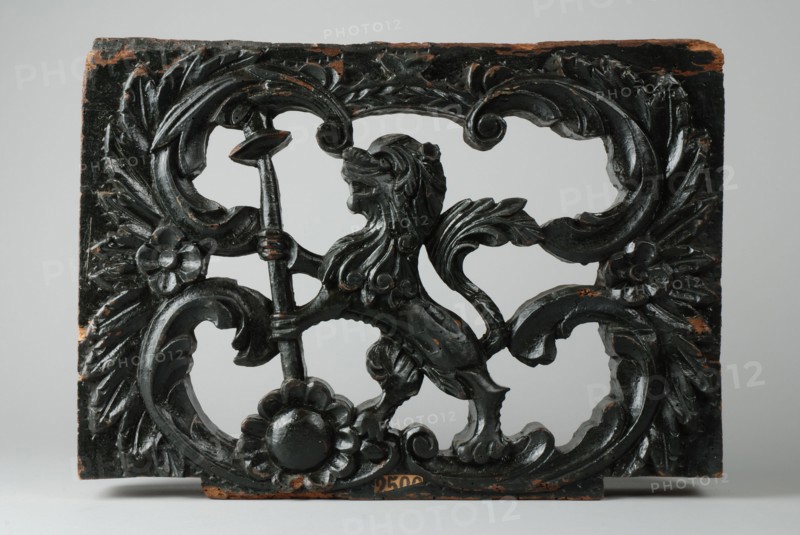 Ornament of wagon, carved lion with spear and hat, ornament part woodcarving sculpture sculpture wood paint, Ornament