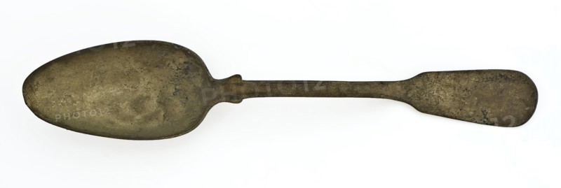 Copper spoon with oval bowl and flat, slightly curved handle with spatula-shaped end, spoon cutlery soil find copper metal