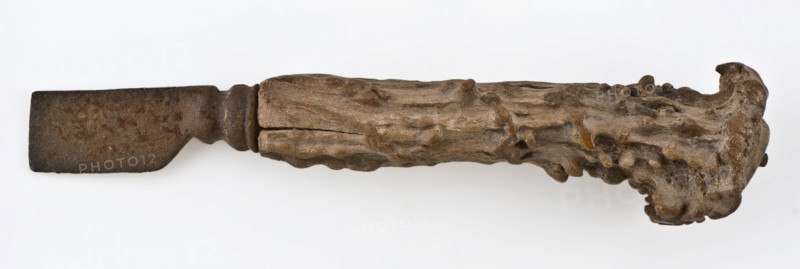 Knife with iron blade and legs raises with capriciously carved decoration, knife cutlery soil find iron bone metal, archeology