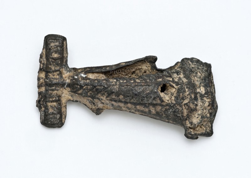 Tin flute or artefact with simple relief decoration, artifact soil find tin metal, cast Pointed object of tin. Decorated