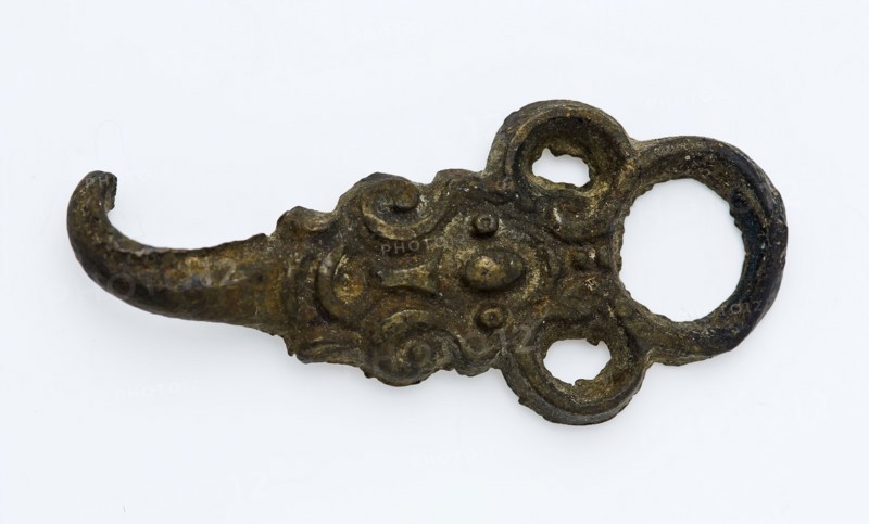 Coat hook or coat closure with ornamental decoration, round eye and bent end as hook, closure clothing accessory clothing soil