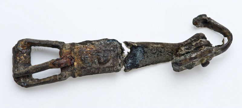 Buckle with leather belt, attachment and end of hook, buckle fastener component soil find copper leather metal, deformed state