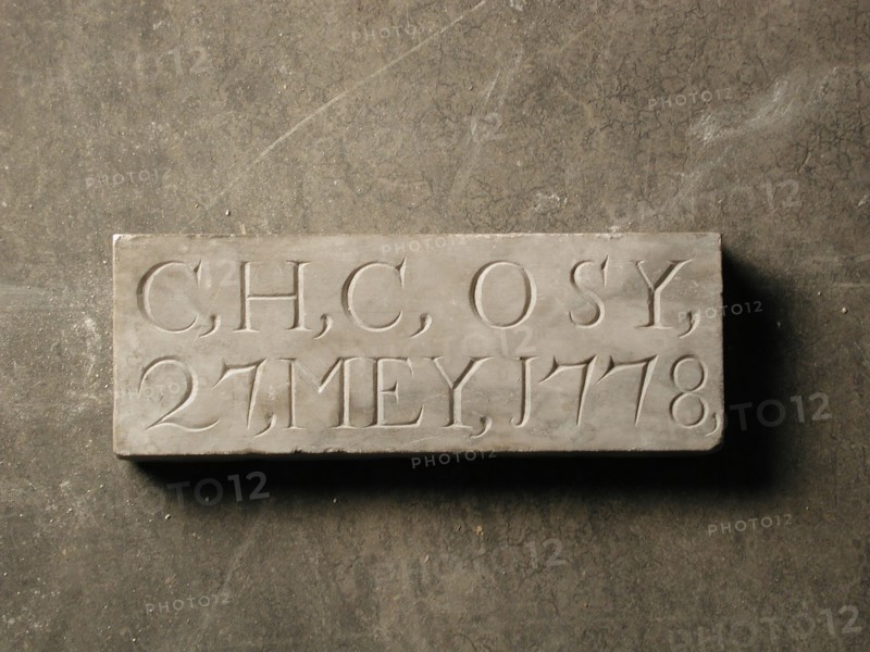 Facade stone with text C, H, C, OSY, 27, MEY, 1778, facing brick foundation stone building block marble stone, minced