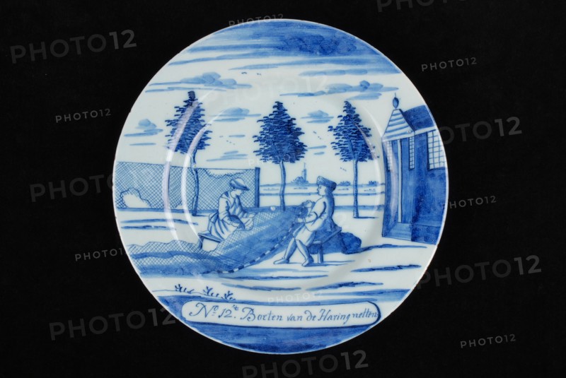 Manufacturer: De Porceleyne Bijl, Series of twelve plates with blue herring industry scenes: No 12. The Fines of the Herringnets