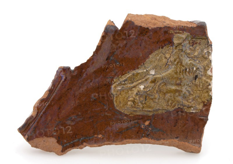 Fragment of earthenware fire dome with lion in relief, firecock fireplaces earthenware ceramic earthenware clay engobe glaze