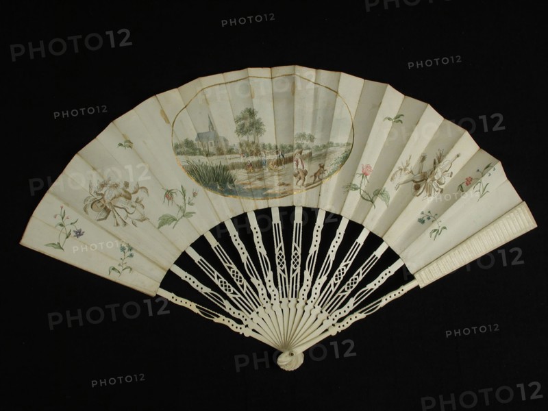Folding fan, frame of cut bone, paper fan blade with central in gold-oval church and field with threshing farmers