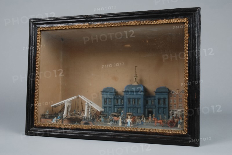 Diorama or viewing box of detailed, polychrome painted cut from Beurs with some buildings next to it, diorama footage cardboard