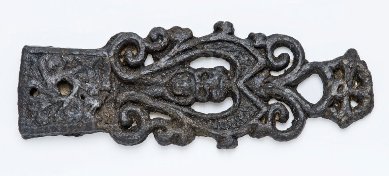 Pewter tongue with lion head and openwork curls, fitting belt clothing accessory clothing soil find tin metal, archeology