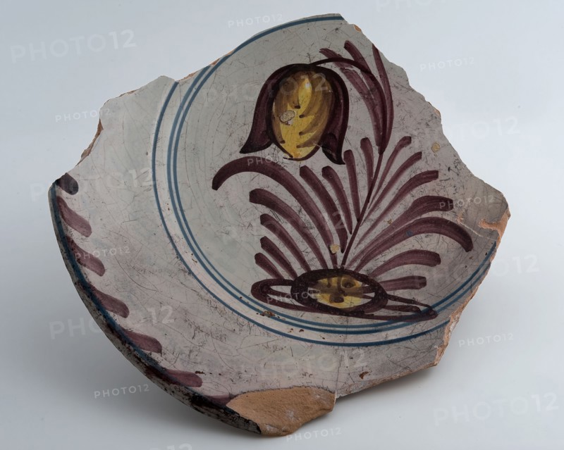 Fragment of dish, yellow shard, polychrome decorated, depicting flowering plant, dish crockery holder soil find ceramic
